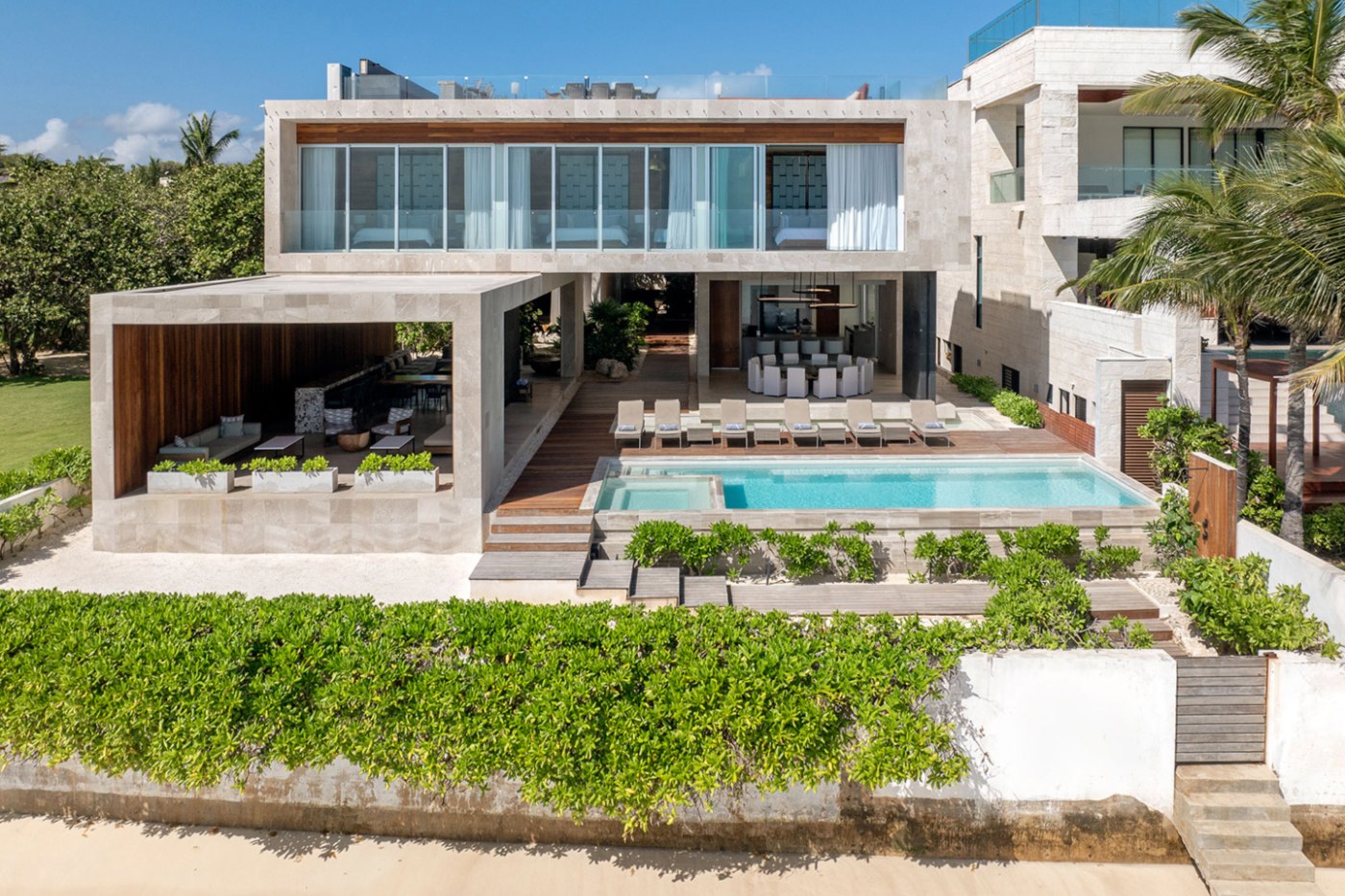 Contemporary villa in Playacar Fase 1 seen from the beach, with pool and terraces