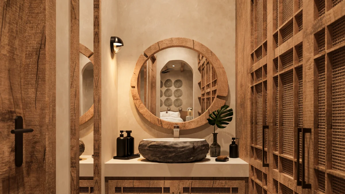 Salle d'eau d'une villa de la Riviera Maya, miroir rond en bois, armoires à façade de cannage et lavabo-vasque en pierre