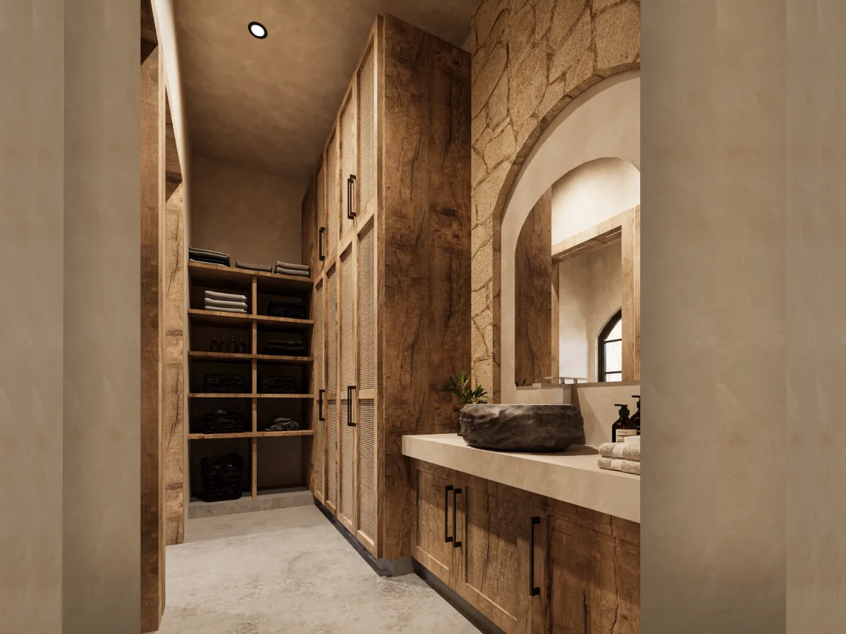 Dressing room and bath of a Riviera Maya house with timber joinery, stone sink and a limestone wall