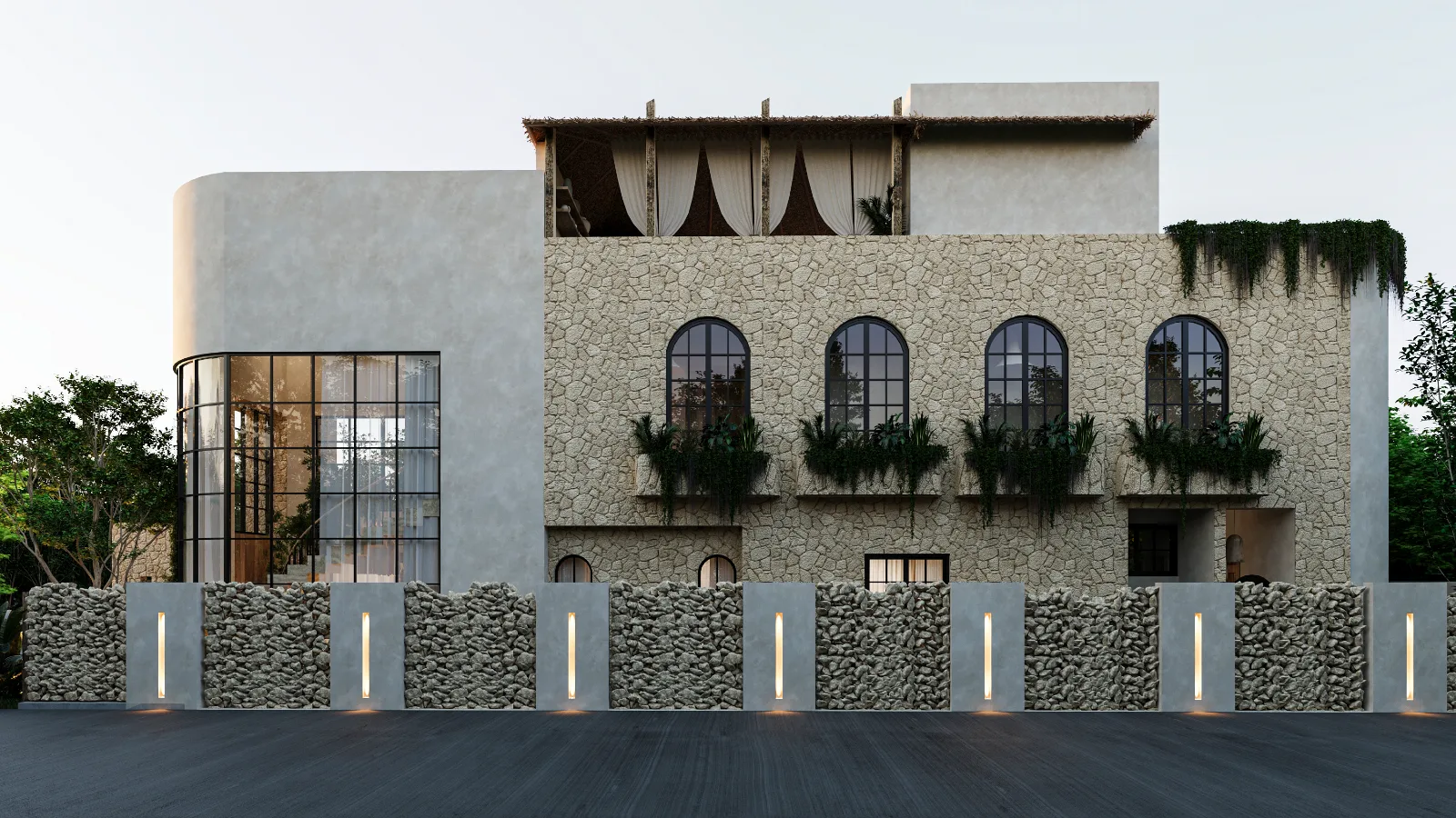 Facade of a Riviera Maya residence seen from the street, limestone wall, arched windows and a rooftop palapa