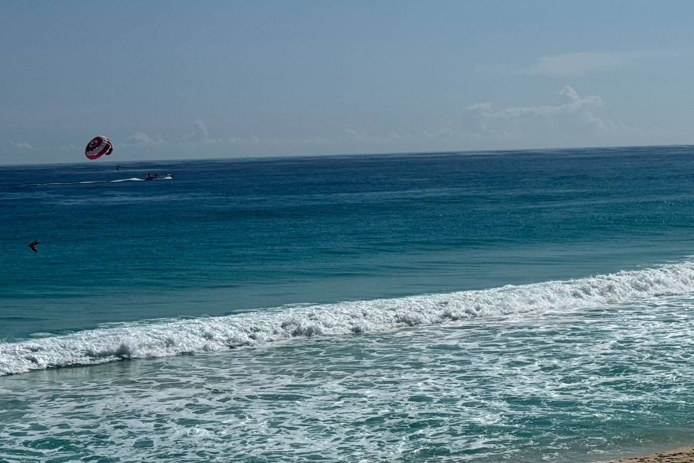 Parasail over the Caribbean off an open sea beach in the Cancún Hotel Zone