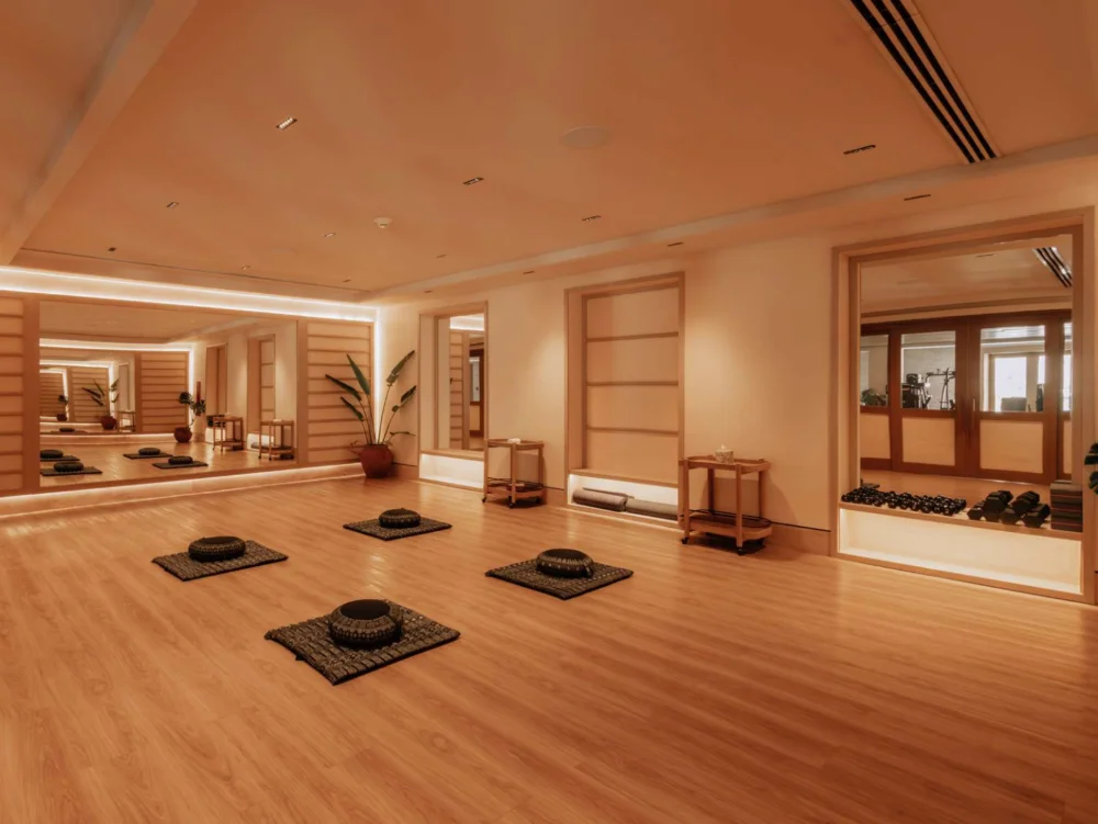 Yoga and movement studio at Costa Residences, Corasol, timber floor and gym behind the glass