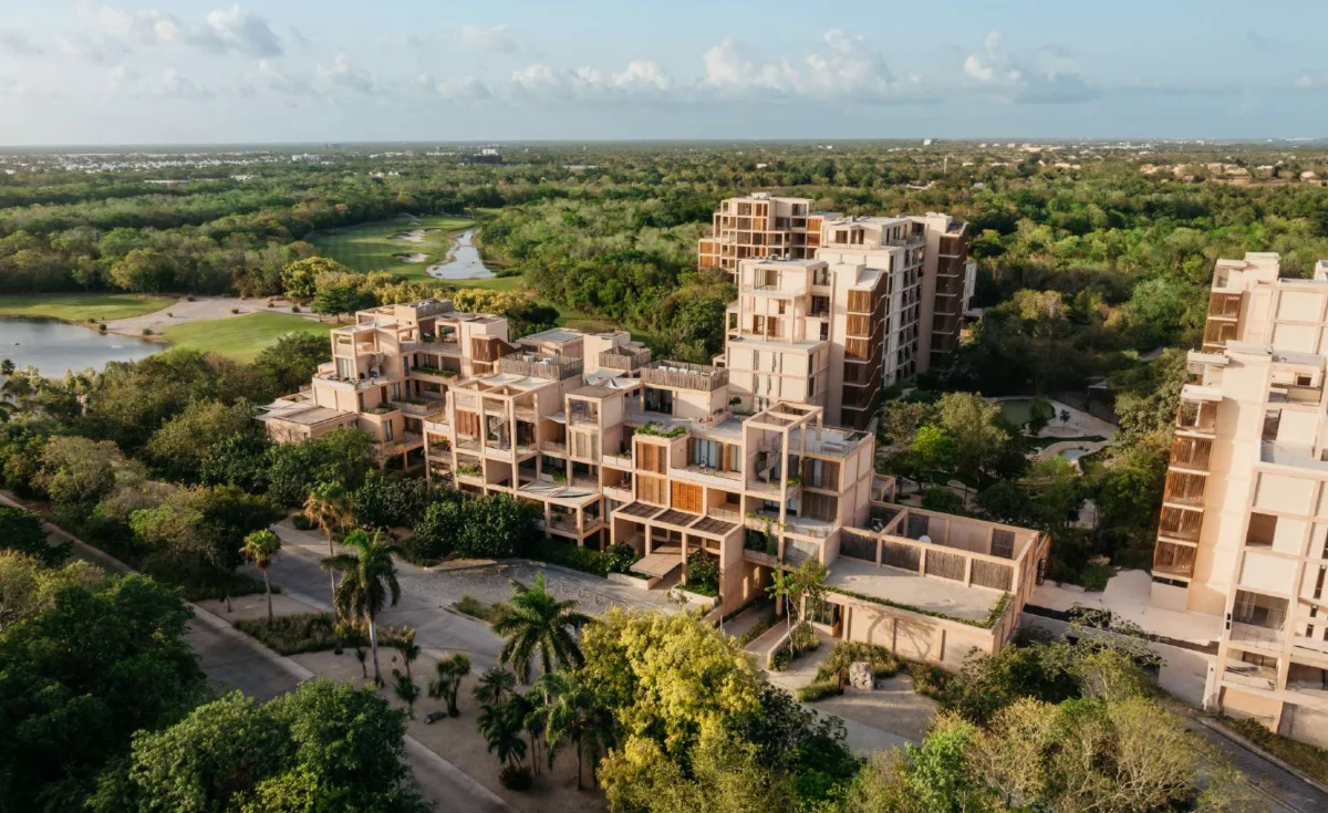 Aerial of The Village at Corasol at sunset, delivered buildings between the golf course, the lake and the mini golf