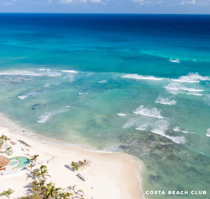 Costa Beach Club at Corasol from the air, white sand and turquoise water
