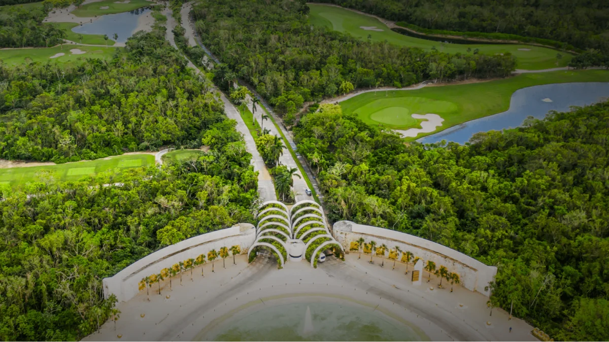 Aerial of the Corasol entry road and gate with the Gran Coyote fairways, lakes and residential land on either side