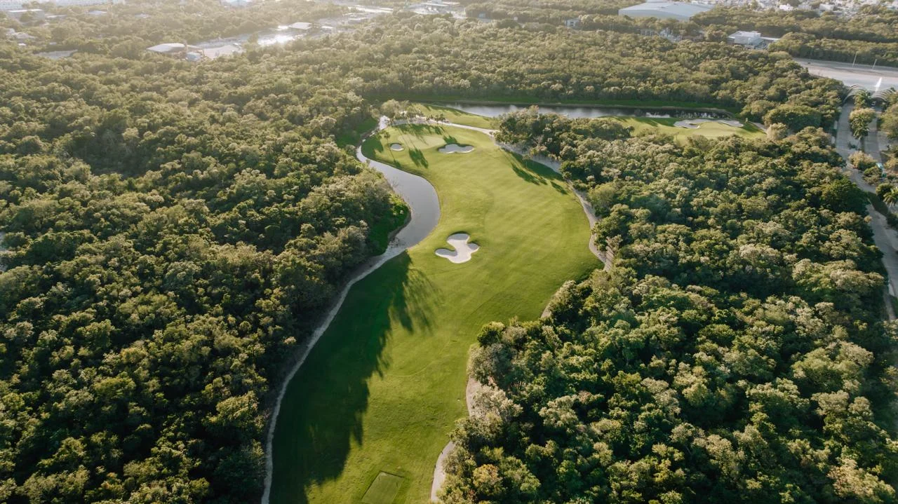 Gran Coyote fairway at Corasol at sunset, jungle on both sides and lakes along the edge