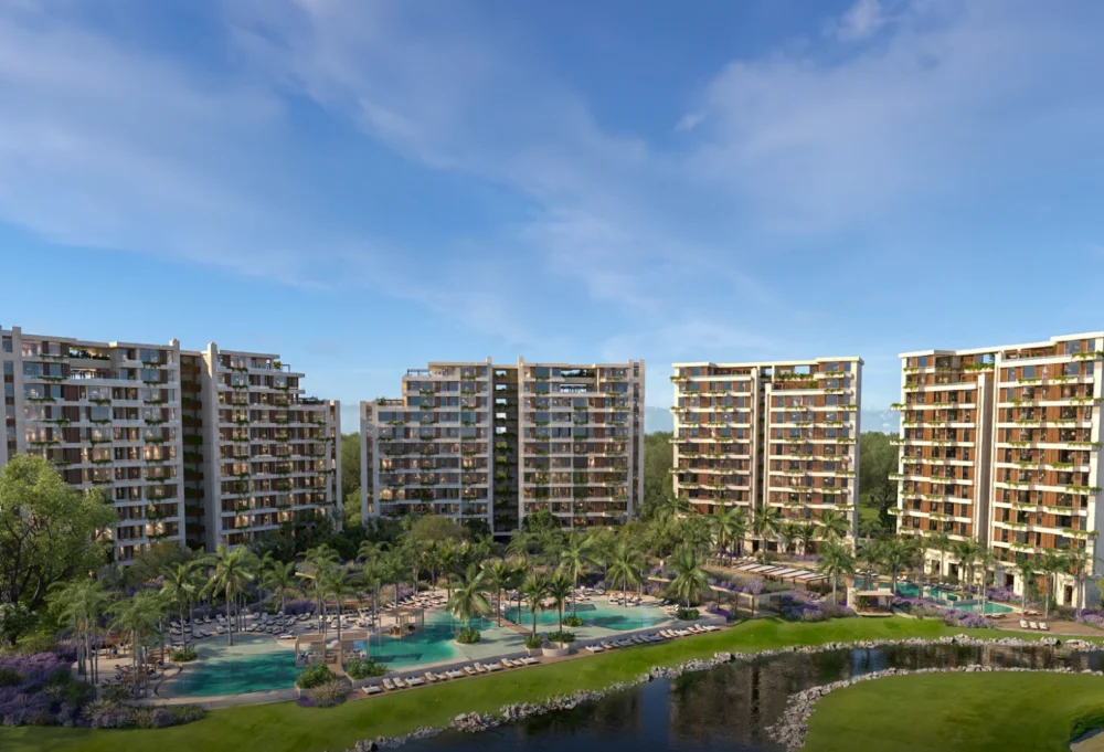 Punta Laguna towers at Corasol seen across the lagoon pools and the golf course