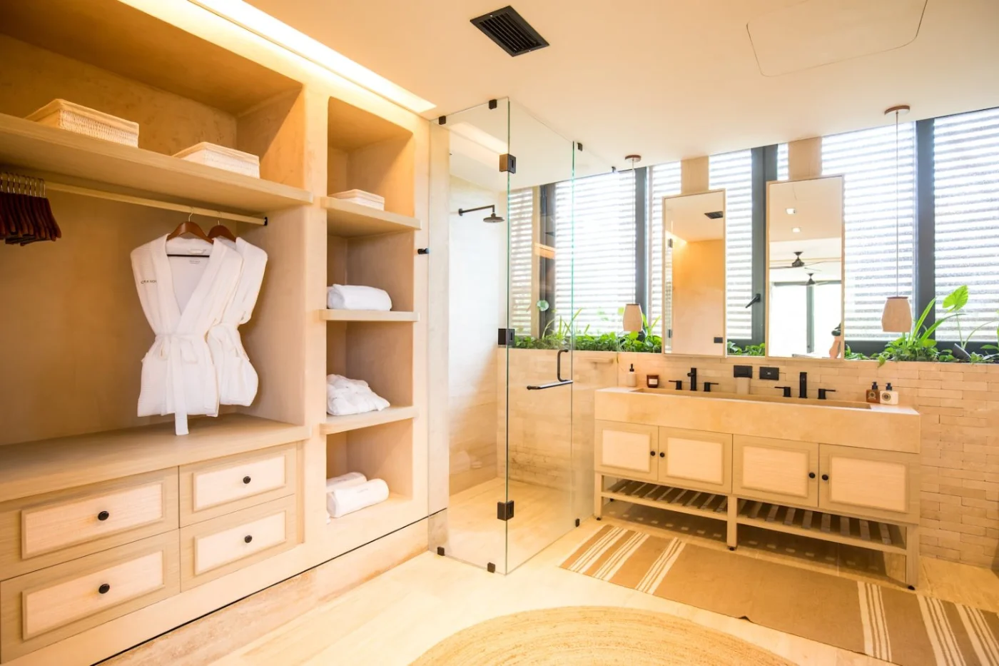Main bathroom of a Palm Villas estate home at Corasol, double stone vanity, walk in shower and dressing area