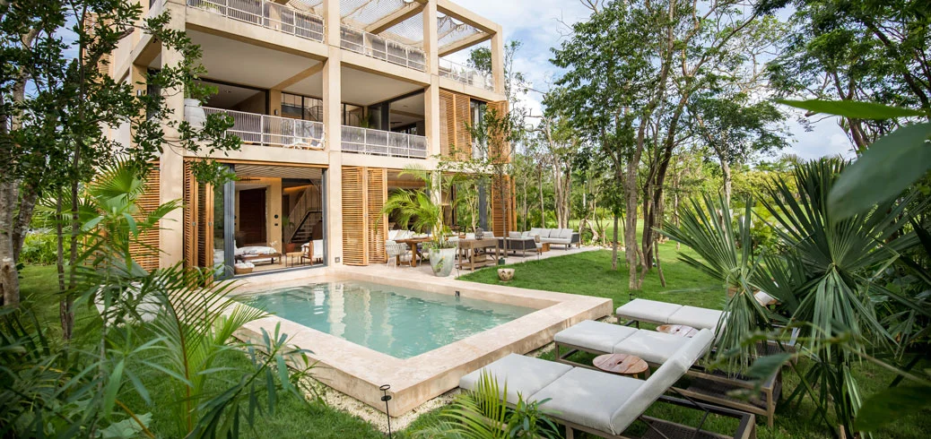 Private pool and garden of a Palm Villas estate home at Corasol, jungle and fairway behind