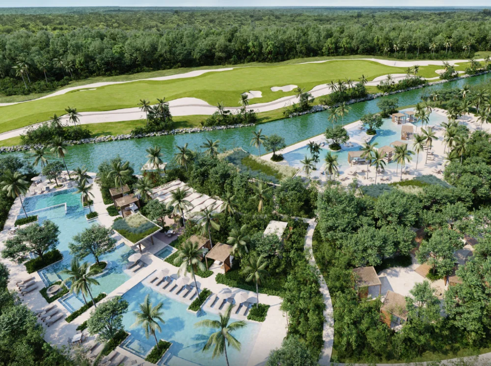 Aerial render of the Punta Laguna pool deck at Corasol, sand entry pools and cabanas beside the water and the fairway