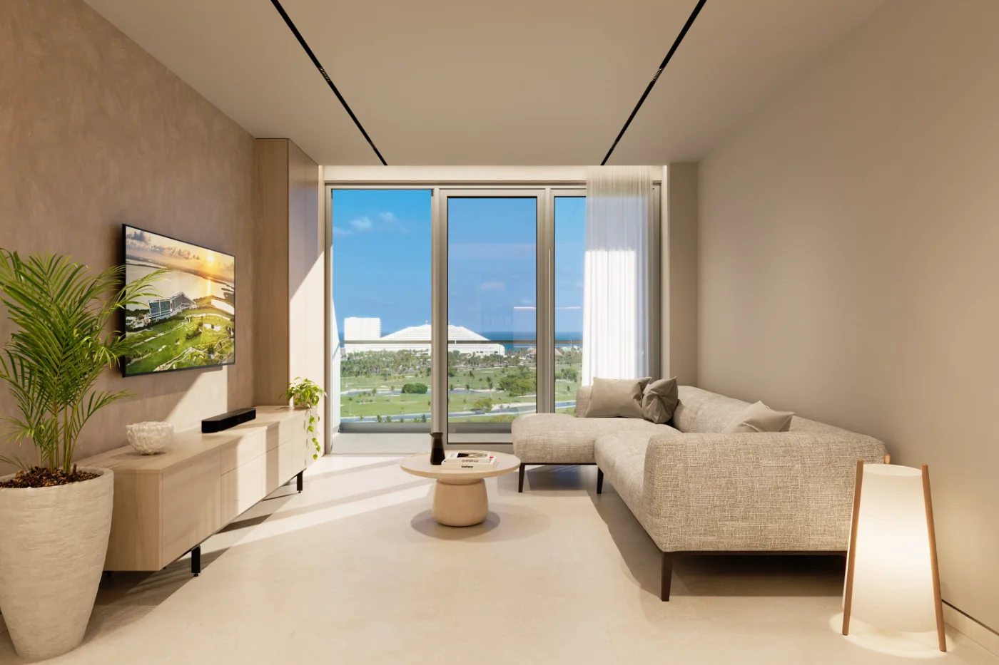 Sala de un condominio nuevo con vista sobre el campo de golf hacia el Caribe