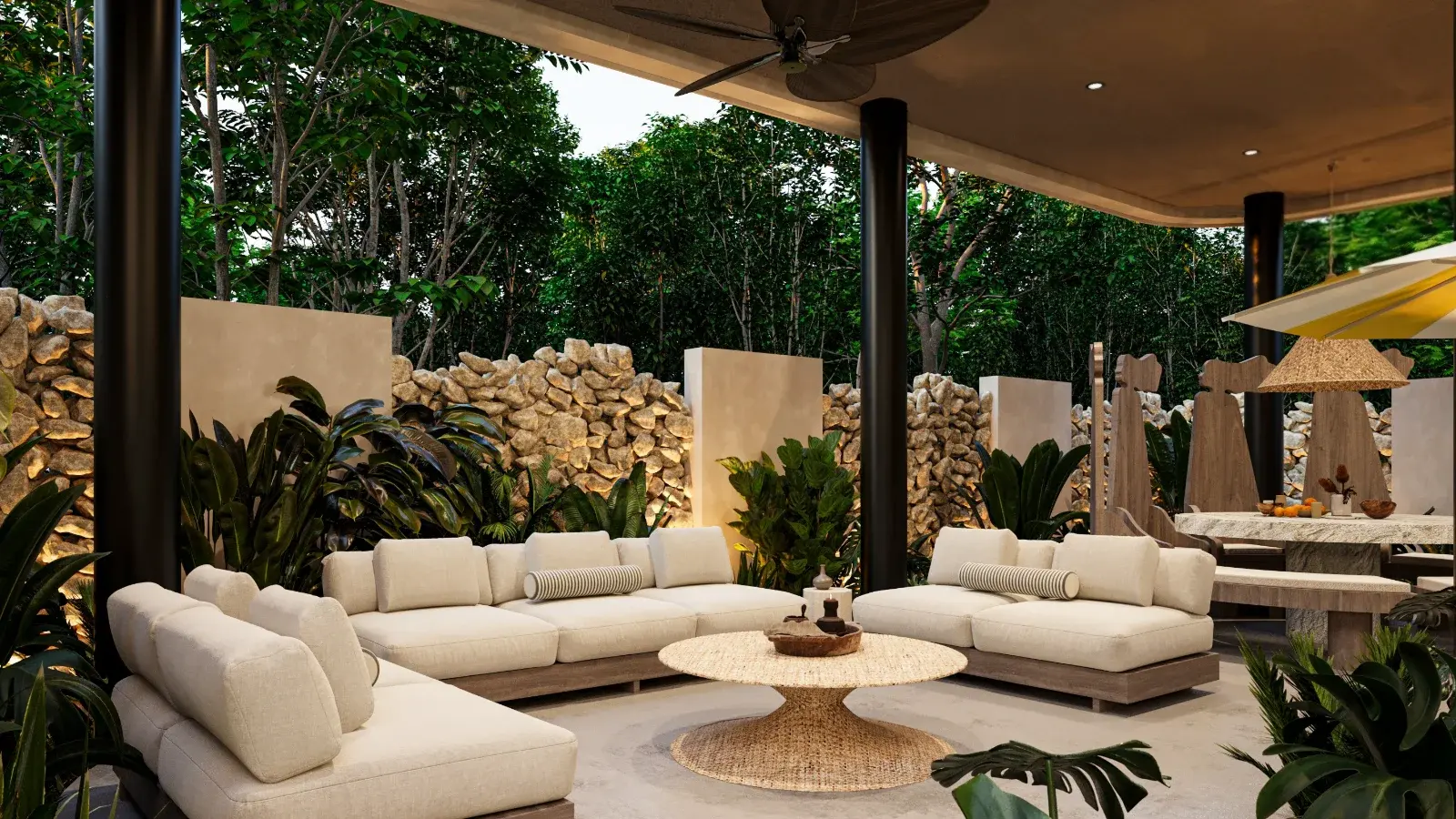 Covered outdoor lounge of a Riviera Maya villa, linen sofas, a stone wall and jungle beyond the terrace