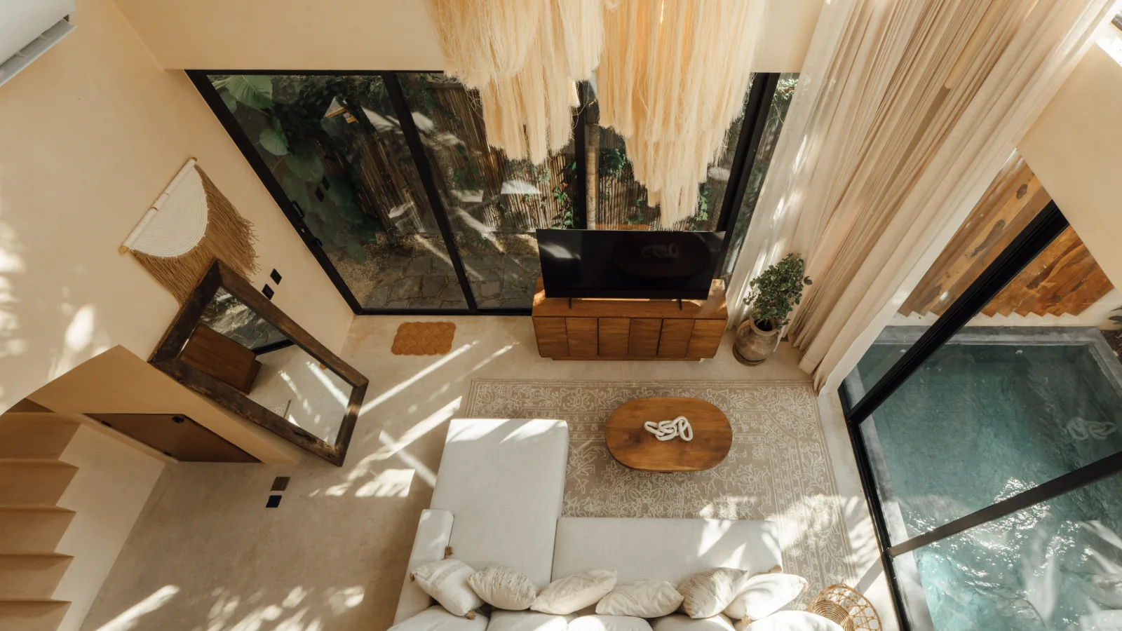 Shaded terrace of a Riviera Maya villa with lounge seating and jungle views