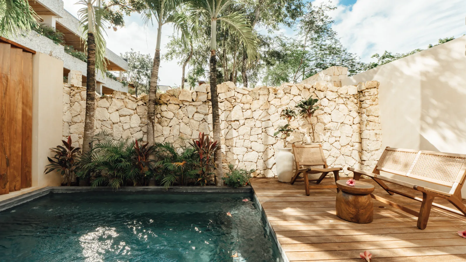 Private plunge pool and shaded terrace of a Riviera Maya villa at dusk
