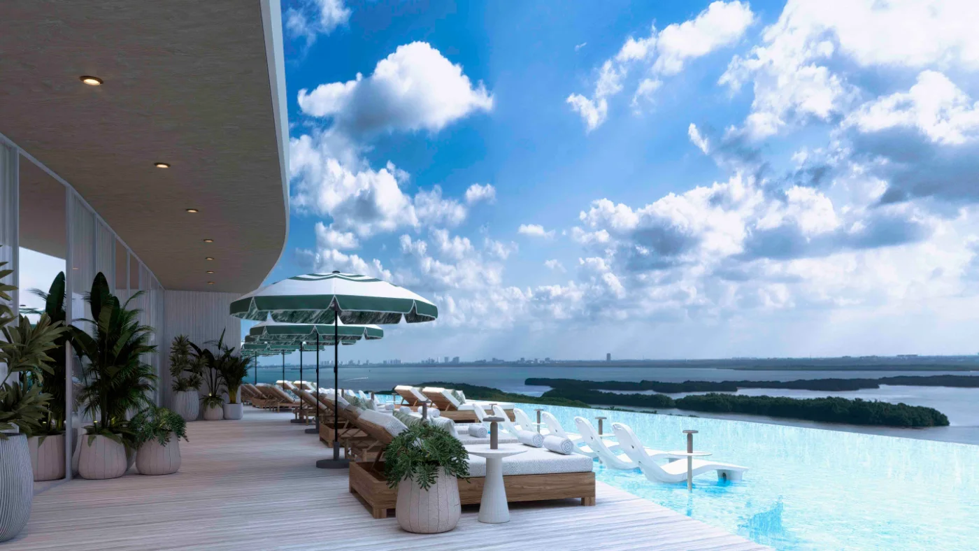 Rooftop infinity pool and sun beds overlooking the lagoon and the city skyline