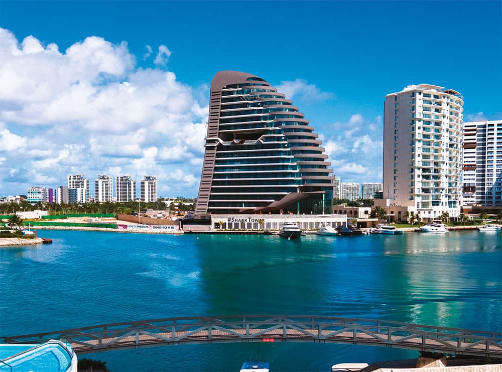 Modern architecture of Marina Condos in Puerto Cancun featuring luxury waterfront apartments and private docks.