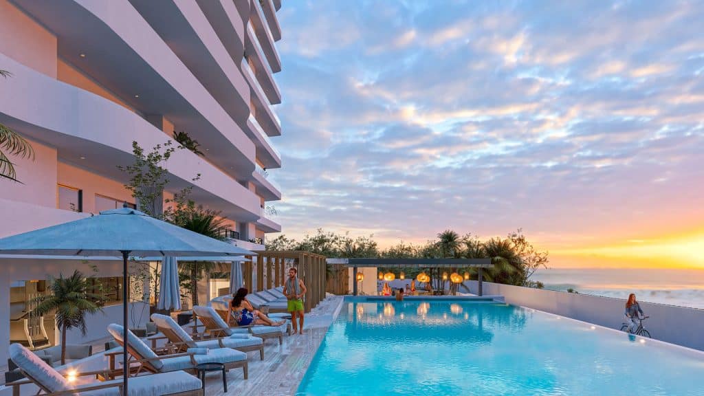 Infinity pool and recreational area amenities in a new Cancun preconstruction development.