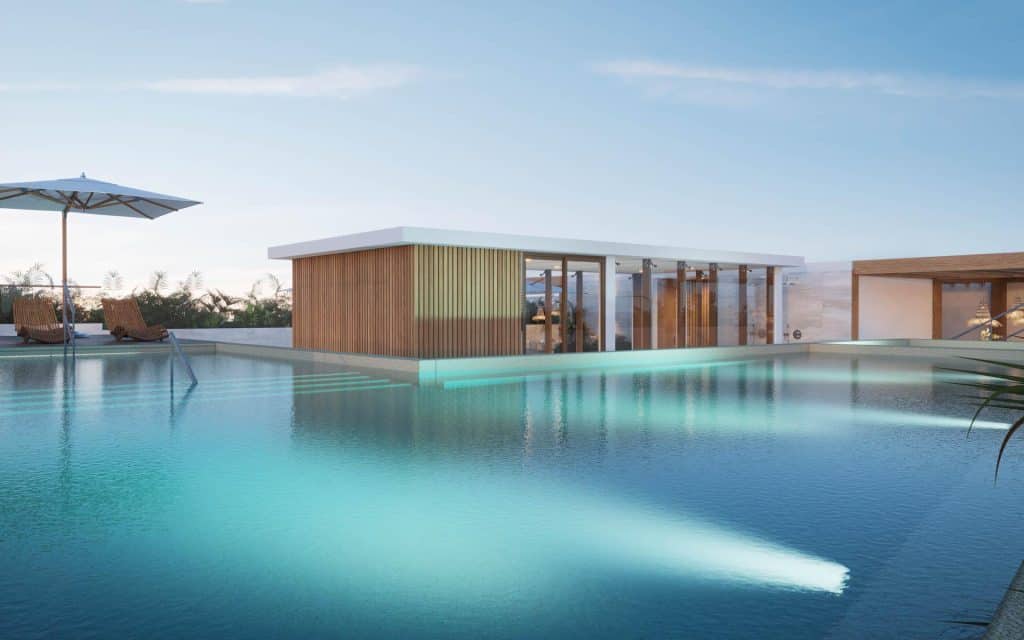 Residents' swimming pool and lounge area at a Cancun condominium complex, offering great value under 200k USD.