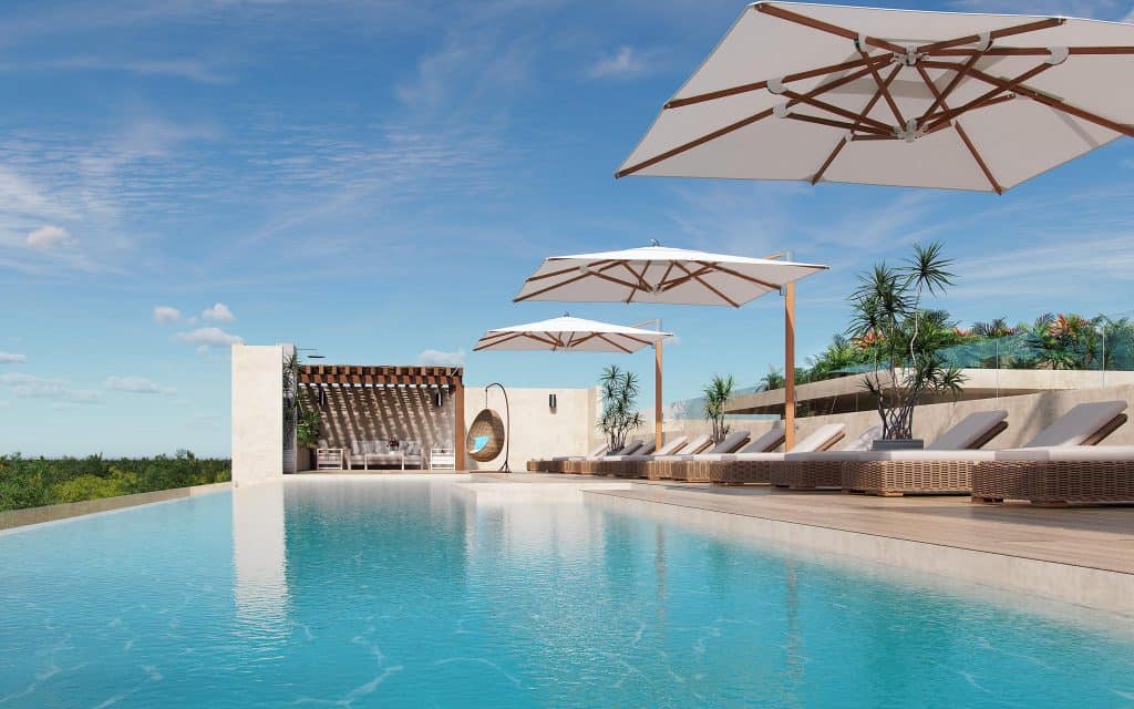 Shared pool and garden area in a secure residential complex in Cancun.